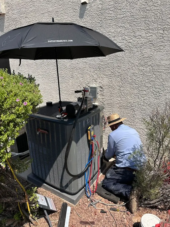 HVAC technician performing outdoor AC maintenance in Snyder